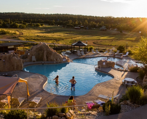 a couple in the swimming pool of the Zion Ponderosa Ranch Resort in St. George, Utah